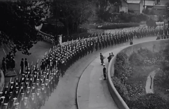 A Royal Navy parade marches past the Governor at Convent Place before making its way into Main Street through Southport Gates.

This remarkable photograph was taken from atop the Southport Gates themselves, offering a perspective rarely seen today. To the right of the marching sailors are the old Sunken Gardens, while just beyond the left edge of the frame lies Trafalgar Cemetery.

#gibraltar #history #wwii #ww2 #heritage

📸 Kenneth Busuttil
